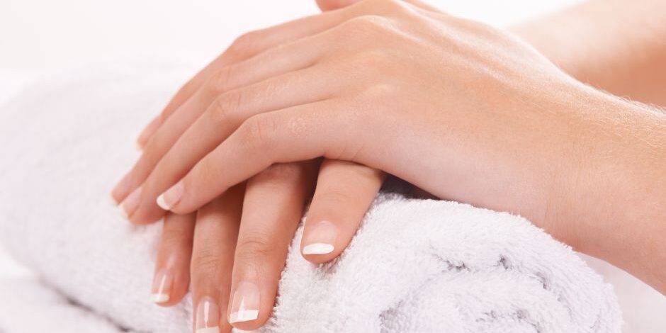 Do I need to let my nails breathe? Image of hands with french polish resting on a rolled white towel